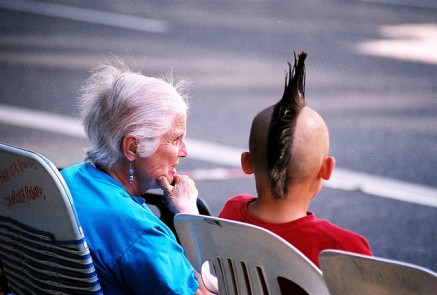 generation gap; old lady talking to boy with mohawk; 